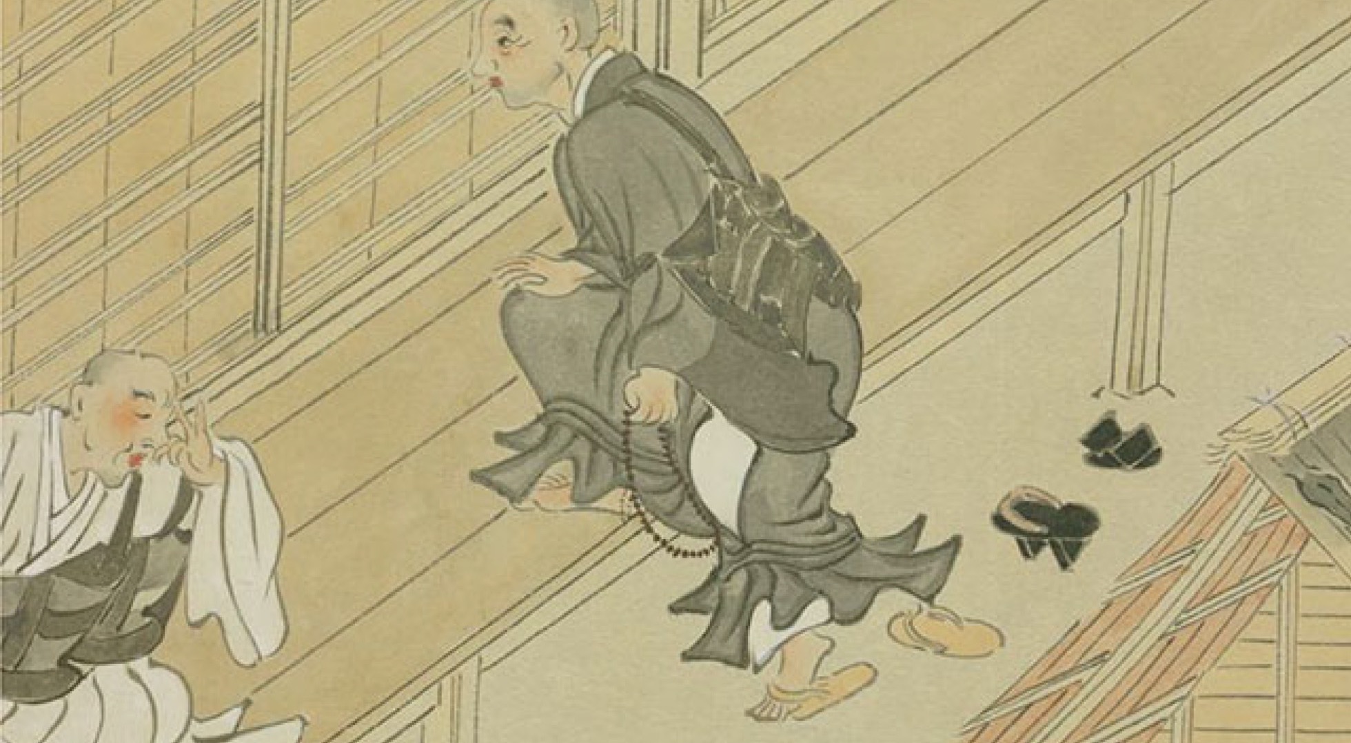 履物を脱いで板の間に上がる僧侶